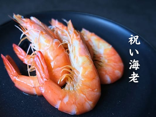 博多久松おせち「博多」弐の重の食材⑭祝い海老。
4匹の調理済みの殻がついたエビが並んでいる。