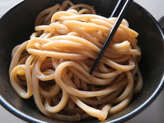 全粒粉が練り込まれたとみ田自家製極太麺のクローズアップ写真