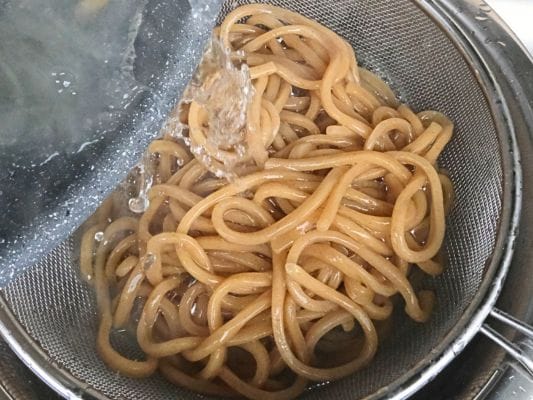 ザルにあげられている極太麺