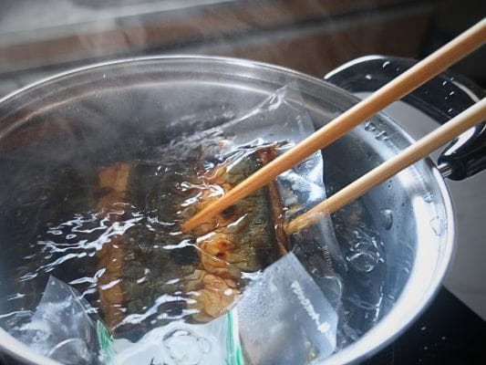 うなぎ処 古賀の蒲焼「竹」を湯煎中に裏返している