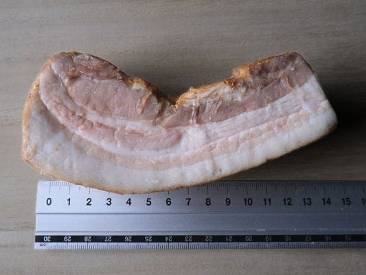 ベーコンブロックの横の長さをブロックのまま定規で測っている様子。横の長さは約15cm。